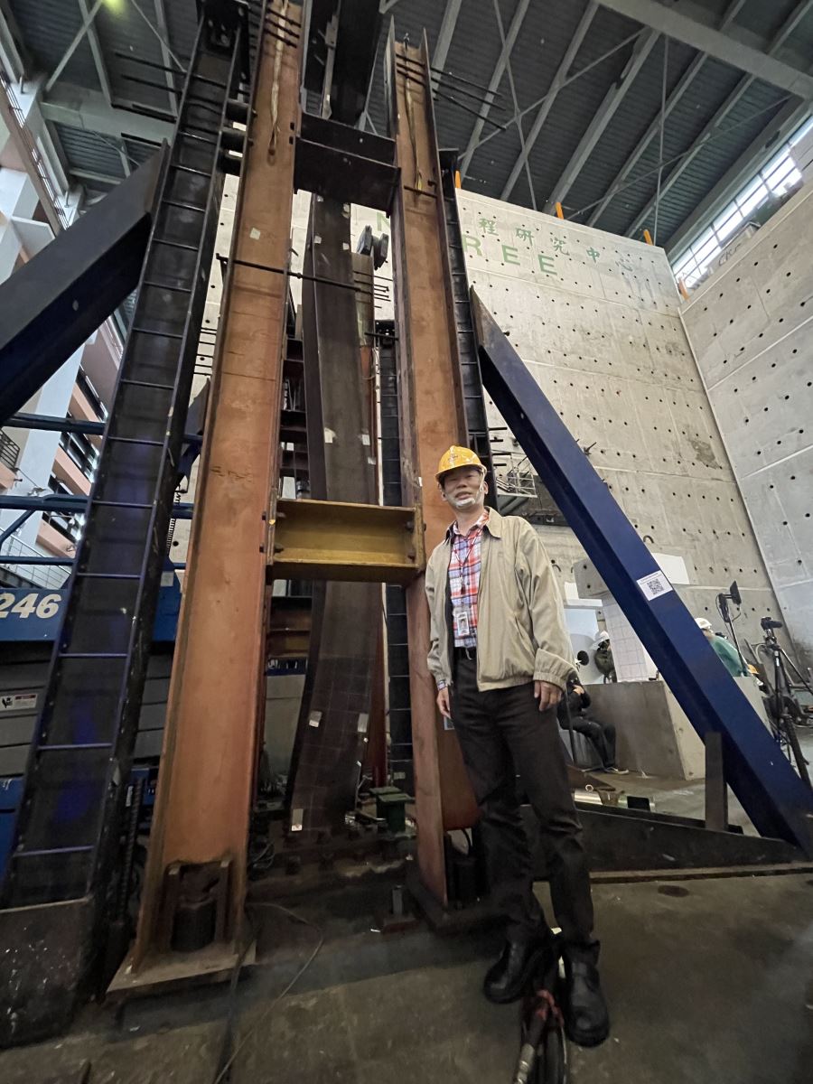 Picture 1: Director Chung-Che Chou posing with steal beams that were bent after an experiment (Photo credit: Pei-Lin Lin)