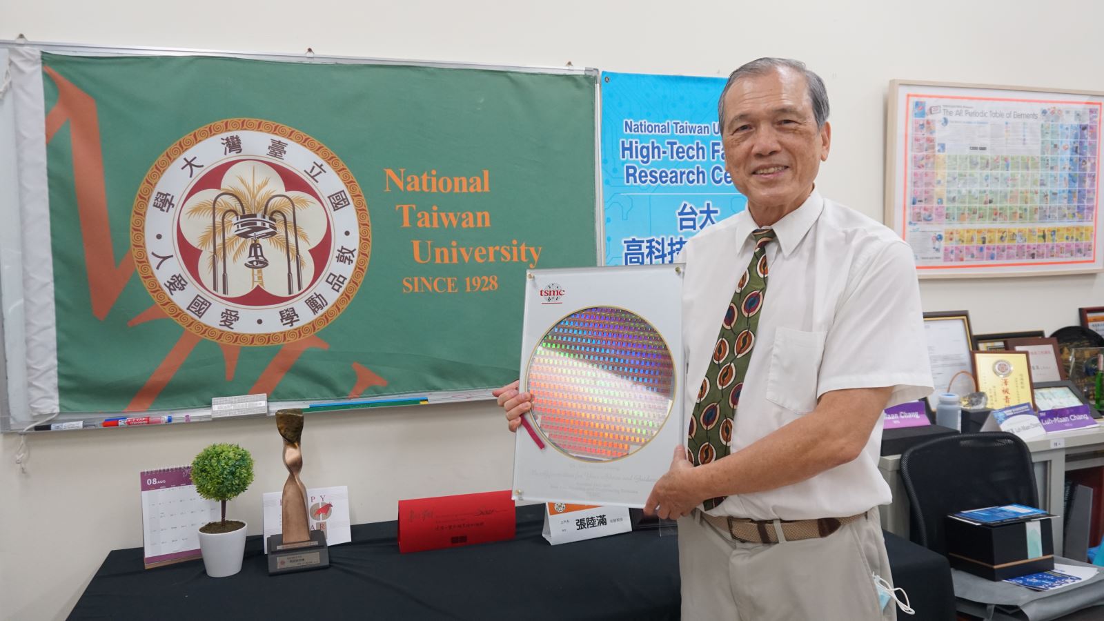 Professor Luh-Maan Chang Holding a 12-inch Wafer
